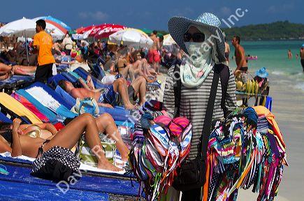 Woman selling bikini's at Chaweng beach on the island of Ko Samui, Thailand.
