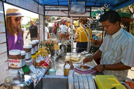 Street food vendors selling flavored pankakes at Chaweng beach village on the island of Ko Samui, Thailand.