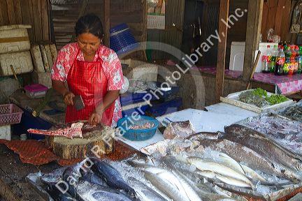 Vendor selling fresh fish at an open air market on the island of Ko Samui, Thailand.