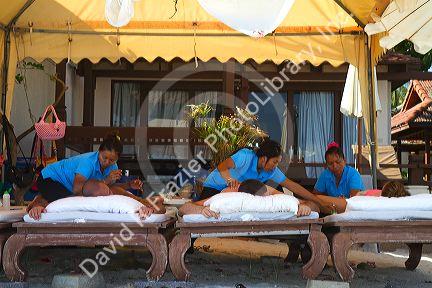People receive Thai massages at Chaweng beach on the island of Ko Samui, Thailand.