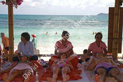 People receive Thai massages at Chaweng beach on the island of Ko Samui, Thailand.