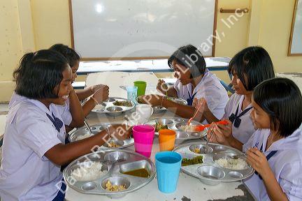 Thai elementary school students eat lunch on the island of Ko Samui, Thailand.