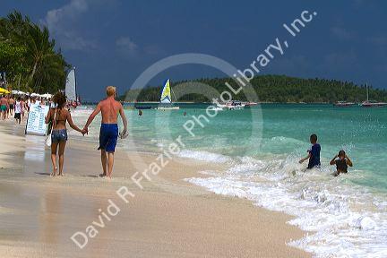 People walk hand in hand along the Gulf of Thailand at Chaweng beach on the island of Ko Samui, Thailand.