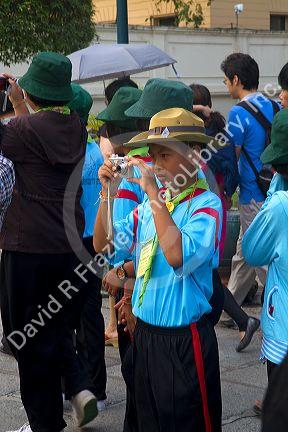 Thai school students wearing Scouting uniforms visit The Grand Palace in Bangkok, Thailand.