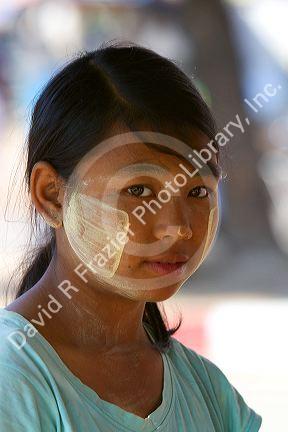 Portrait of a Burmese girl wearing thanaka on his cheeks in (Rangoon) Yangon, (Burma) Myanmar.