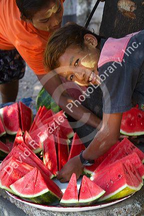 Street vendor selling sliced watermelon in (Rangoon) Yangon, (Burma) Myanmar.