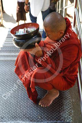 Buddhist monk with alms bowl in (Rangoon) Yangon, (Burma) Myanmar.