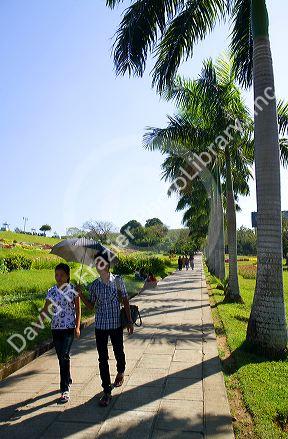 People walk along Inya Lake in (Rangoon) Yangon, (Burma) Myanmar.