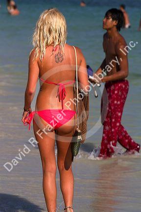 Woman wearing a bikini at Chaweng beach in the Gulf of Thailand on the island of Ko Samui, Thailand.