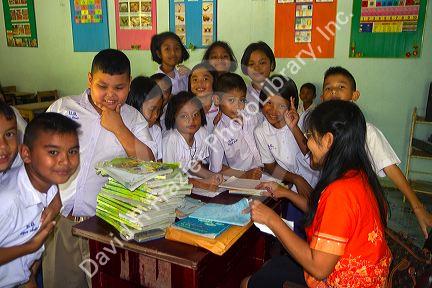 Teacher and students at a Thai elementary school on the island of Ko Samui, Thailand.