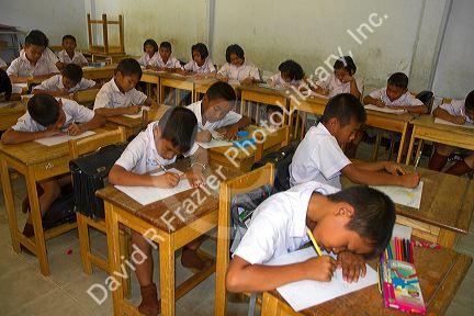 Thai elementary school students sit a desks on the island of Ko Samui, Thailand.