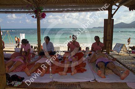 People receive Thai massages at Chaweng beach on the island of Ko Samui, Thailand.