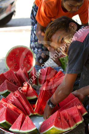 Street vendor selling sliced watermelon in (Rangoon) Yangon, (Burma) Myanmar.