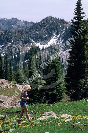 Girl hiking in an Idaho mountain meadow. MR