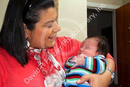 Hispanic mother holding her infant son in Boise, Idaho, USA. MR