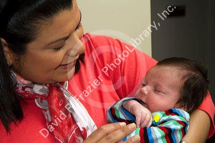 Hispanic mother holding her infant son in Boise, Idaho, USA. MR