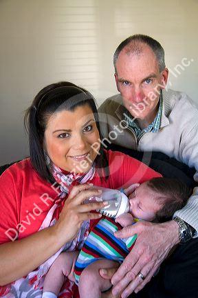 Caucasian father and hispanic mother with their infant son in Boise, Idaho, USA. MR