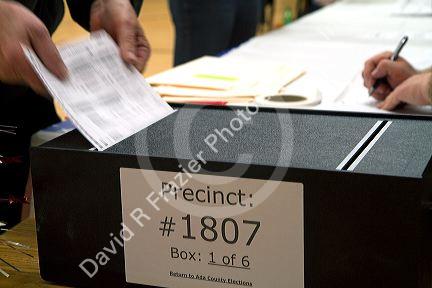 Voted ballot being put into a ballot box in Boise, Idaho, USA.