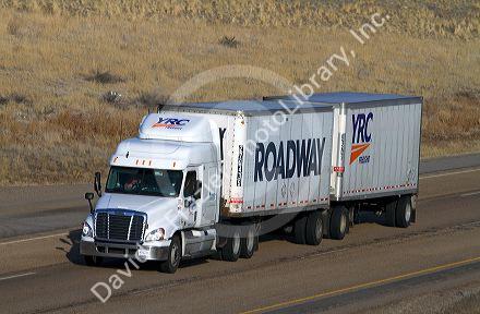 Semi truck hauling a double trailer on Interstate 84 near Boise, Idaho, USA.