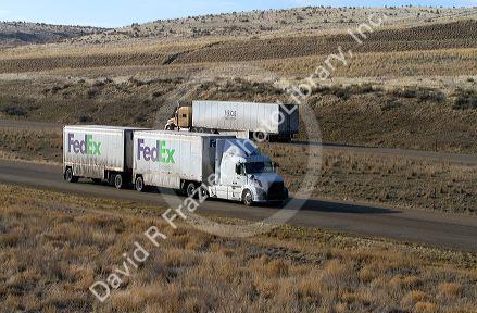 Semi truck hauling a double trailer on Interstate 84 near Boise, Idaho, USA.