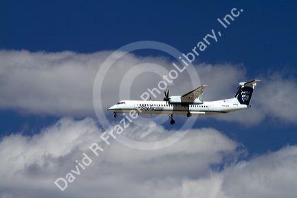 Alaska airlines Bombardier Q400 commuter airplane in flight.