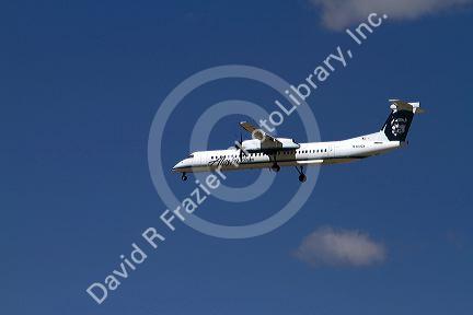 Alaska airlines Bombardier Q400 commuter airplane in flight.