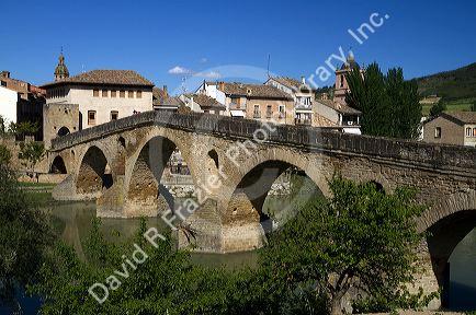 Six-arched Roman bridge spanning the Arga River on the Way of St. James pilgrimage route in Puente La Reina, Navarra, Spain.