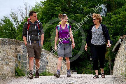 Modern day pilgrims walk along the Camino De Santiago, the Way of St. James pilgrimage route, Navarra, Spain.
