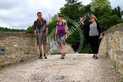 Modern day pilgrims walk along the Camino De Santiago, the Way of St. James pilgrimage route, Navarra, Spain.