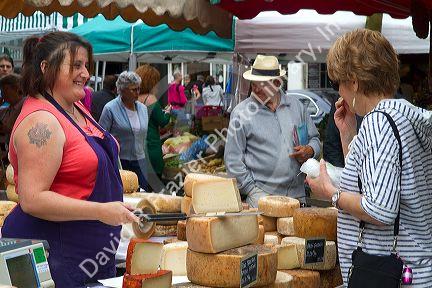American tourist purchasing cheese at a Basque market at Saint-Jean-de-Luz in the Basque province of Labourd, southwestern France.