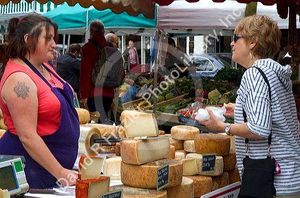 American tourist purchasing cheese at a Basque market at Saint-Jean-de-Luz in the Basque province of Labourd, southwestern France.