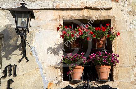 Flower pots in the window of a building in the village of Santillana del Mar, Cantabria, Spain.