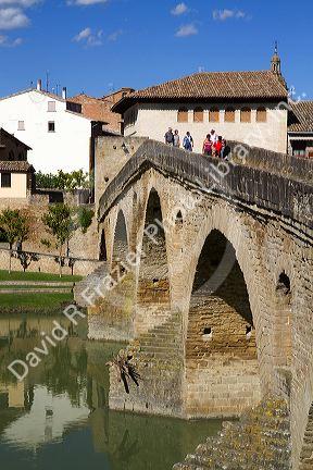 Six-arched Roman bridge spanning the Arga River on the Way of St. James pilgrimage route in Puente La Reina, Navarra, Spain.