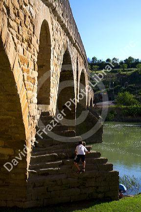 Six-arched Roman bridge spanning the Arga River on the Way of St. James pilgrimage route in Puente La Reina, Navarra, Spain.