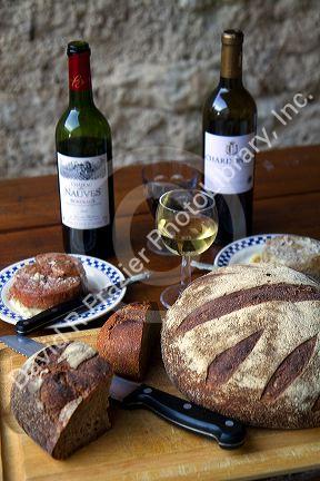 Wine, bread, and pate displayed on a french farm table near Angouleme in southwestern France.