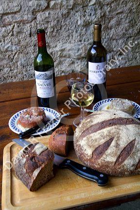 Wine, bread, and pate displayed on a french farm table near Angouleme in southwestern France.