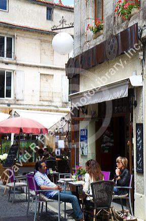 People sit at an outdoor cafe at Angouleme in southwestern France.