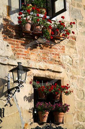 Flower pots in the window of a building in the village of Santillana del Mar, Cantabria, Spain.