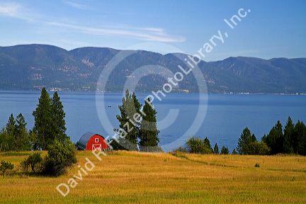 Red barn and farmland along Flathead Lake, Montana, USA.