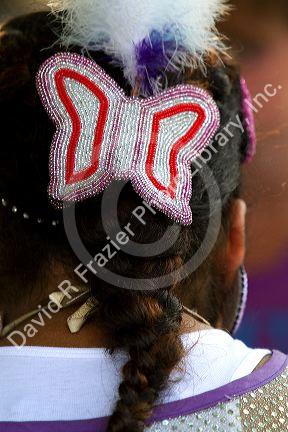 Blackfoot indian girl wearing a beaded butterfly hair barrette at the Blackfoot Arts and Heritage Festival at Waterton Park townsite in Waterton Lakes National Park, Alberta, Canada.