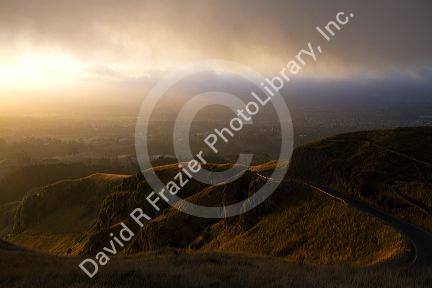 Mountain pass with fog at sunset near Hamilton in the Waikato Region, North Island, New Zealand.
