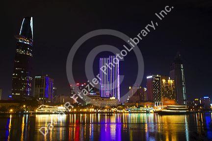 Night view of city lights reflected on the Saigon River in Ho Chi Minh City, Vietnam.