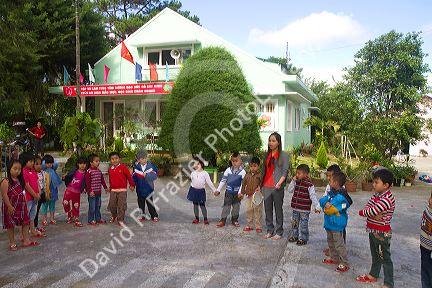 Young students outdoors at an elementary school in Da Lat, Vietnam.
