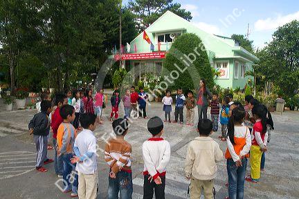 Young students outdoors at an elementary school in Da Lat, Vietnam.