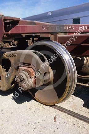 An iron wheel on a railroad car.