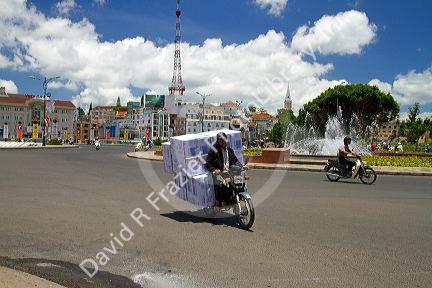 People riding scooters on the street in Da Lat, Vietnam.