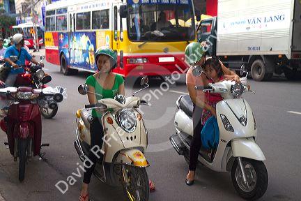Vietnamese people riding motor scooters in Nha Trang, Vietnam,