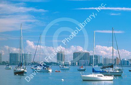 Boats at anchor off Long Boat Key with Sarasota, Florida skyline in background.