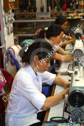 Workers using sewing machines at a clothing factory in Hanoi, Vietnam.