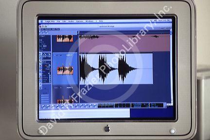 Sound engineer examines a spectrogram on a computer screen.